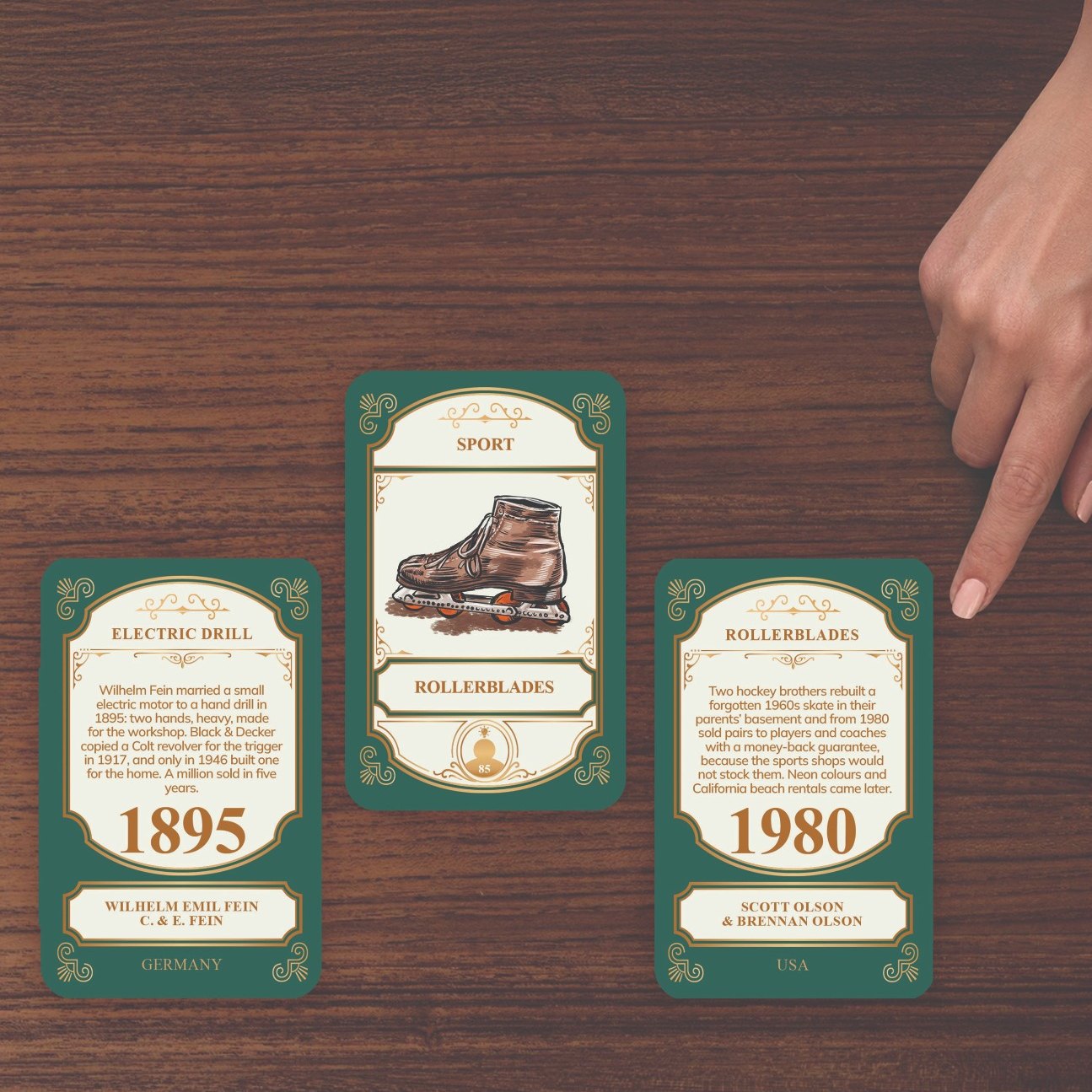 Three cards in a row, the middle one still hiding its year, a second hand pointing at it